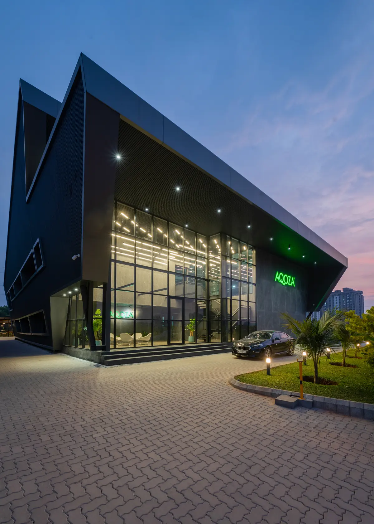 AQOZA headquarters building in Kochi at dusk